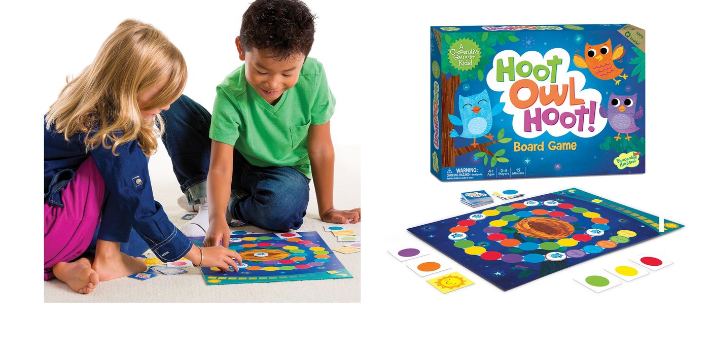 Two kids playing the Hoot Owl Hoot cooperative board game
