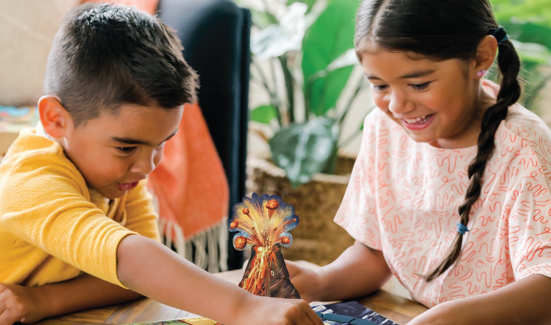 Two kids playing a Peaceable Kingdom cooperative board game together
