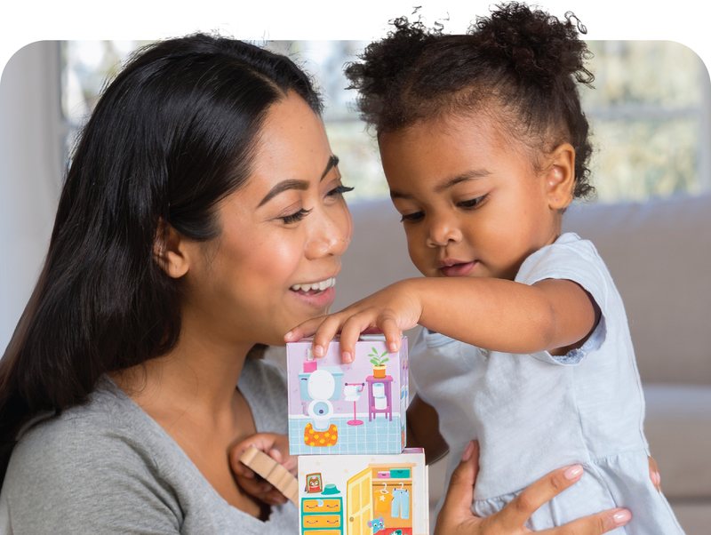 Mom and toddler playing a Peaceable Kingdom stacking game