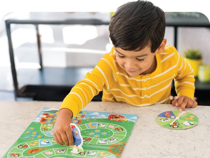 Preschooler playing a Peaceable Kingdom learning game